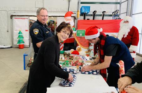 Chief Caldera and his wife Vicki Caldera wrapping gifts for their assigned child