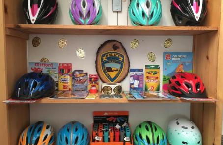 Bike helmets and other donated items displayed on shelves