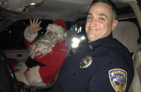 Officer Flatau with Santa Claus (Councilman Bob Deeno)